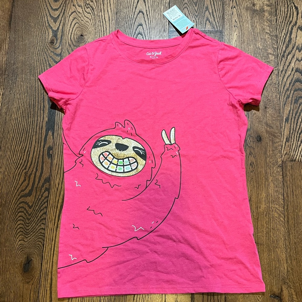 A sparkly sloth that is a pink tea shirt